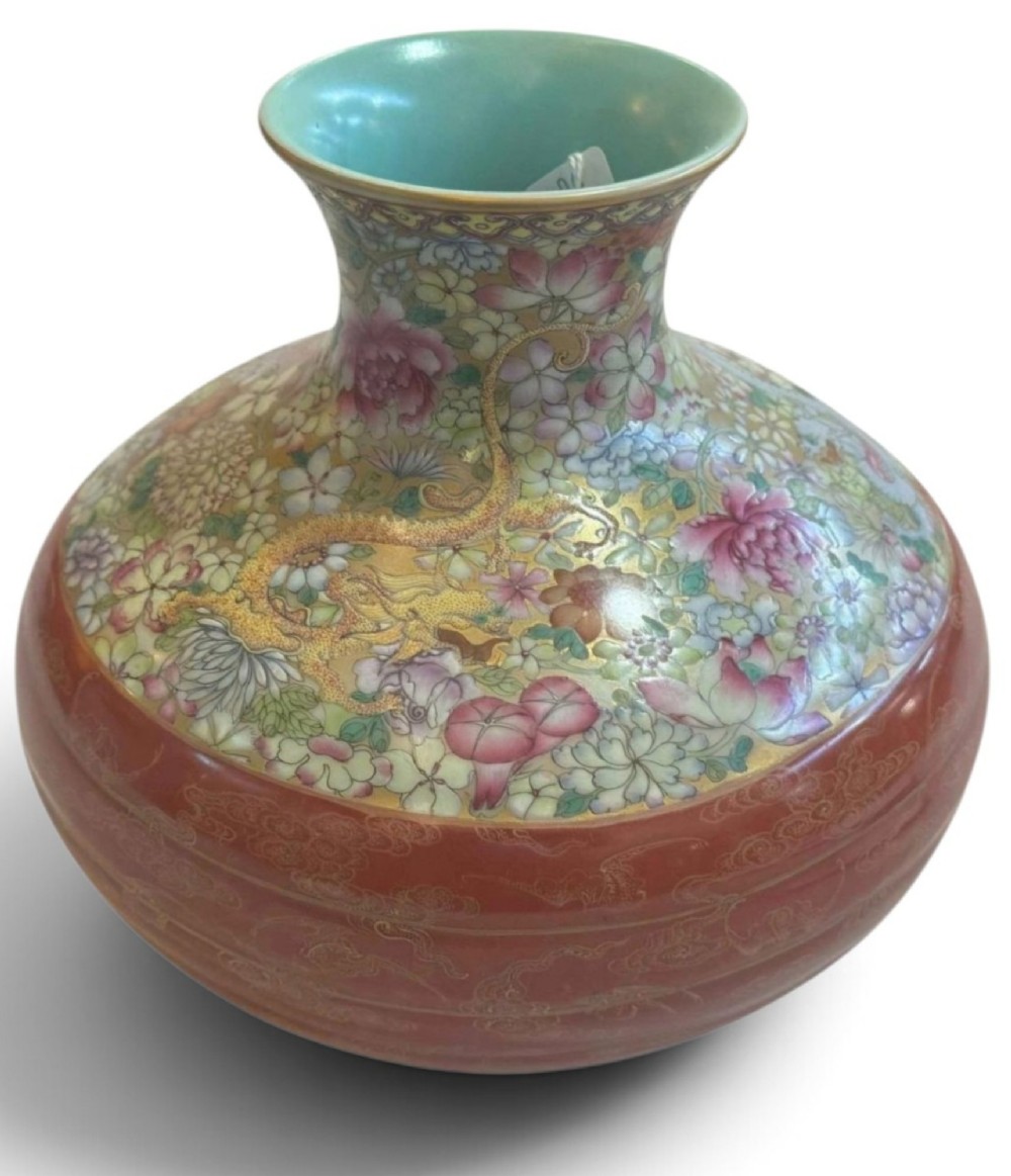 A spherical porcelain vase decorated with a dense millefleurs floral pattern, dual dragon motifs, a tied iron-red ribbon motif, and a turquoise interior rim. View X