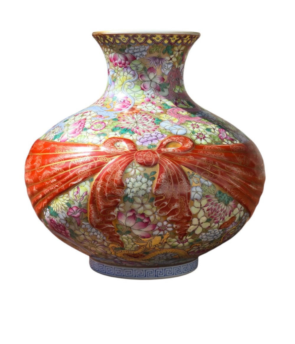 A spherical porcelain vase decorated with a dense millefleurs floral pattern, dual dragon motifs, a tied iron-red ribbon motif, and a turquoise interior rim. View XII