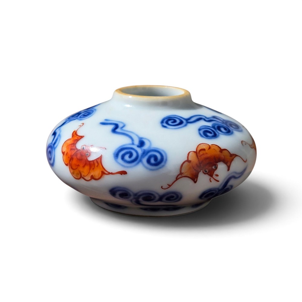 A squatted Chinese porcelain brush washer decorated with underglaze cobalt blue clouds and copper red bats on a white glazed ground. View VIII