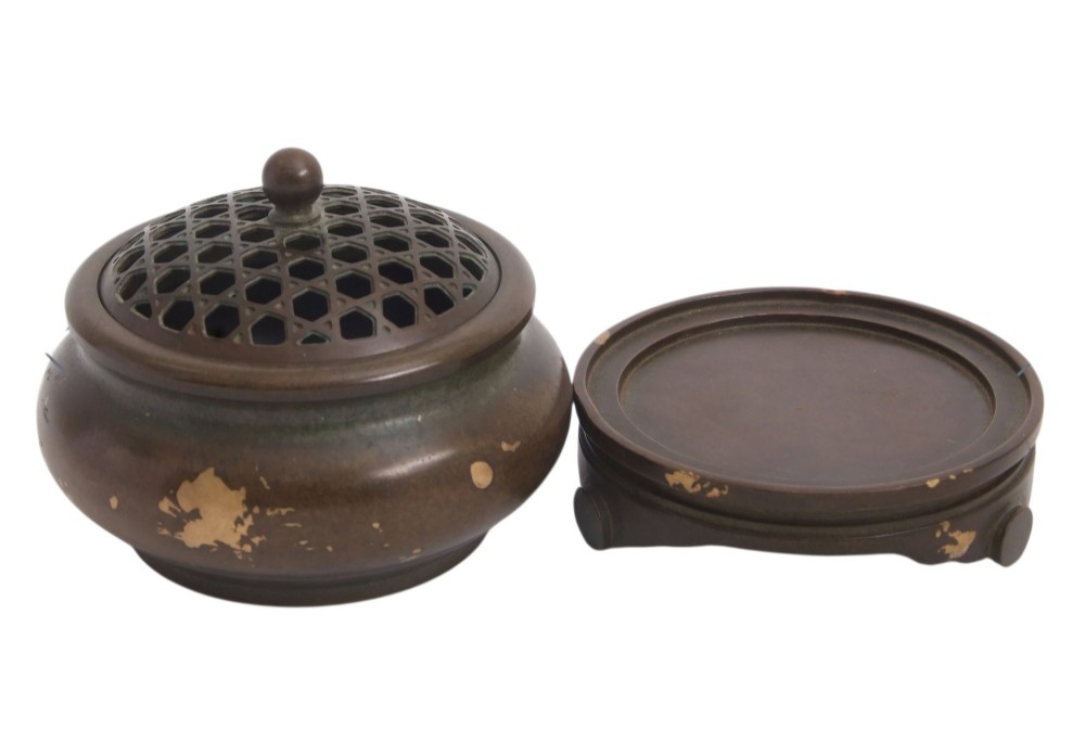 A dark brown bronze circular censer featuring gold splash decoration, a reticulated lattice cover with a spherical finial, and a matching footed bronze stand. View IX
