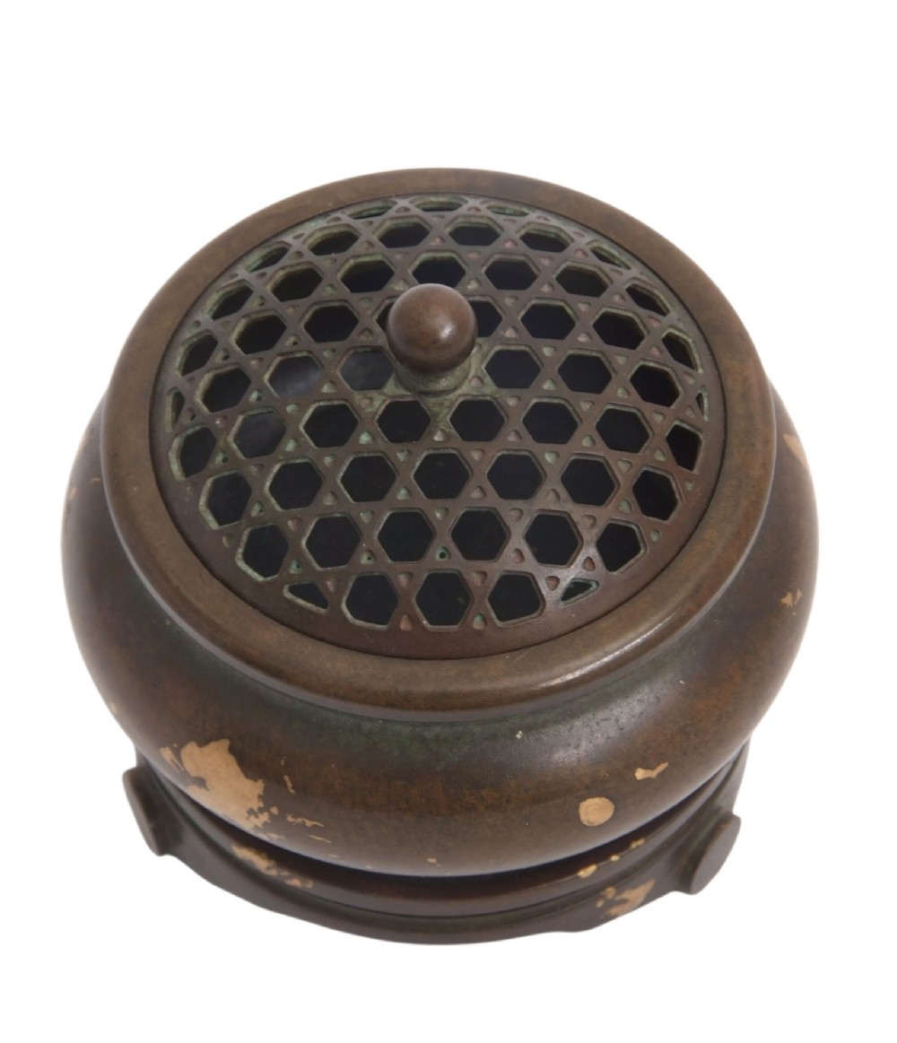 A dark brown bronze circular censer featuring gold splash decoration, a reticulated lattice cover with a spherical finial, and a matching footed bronze stand. View XI