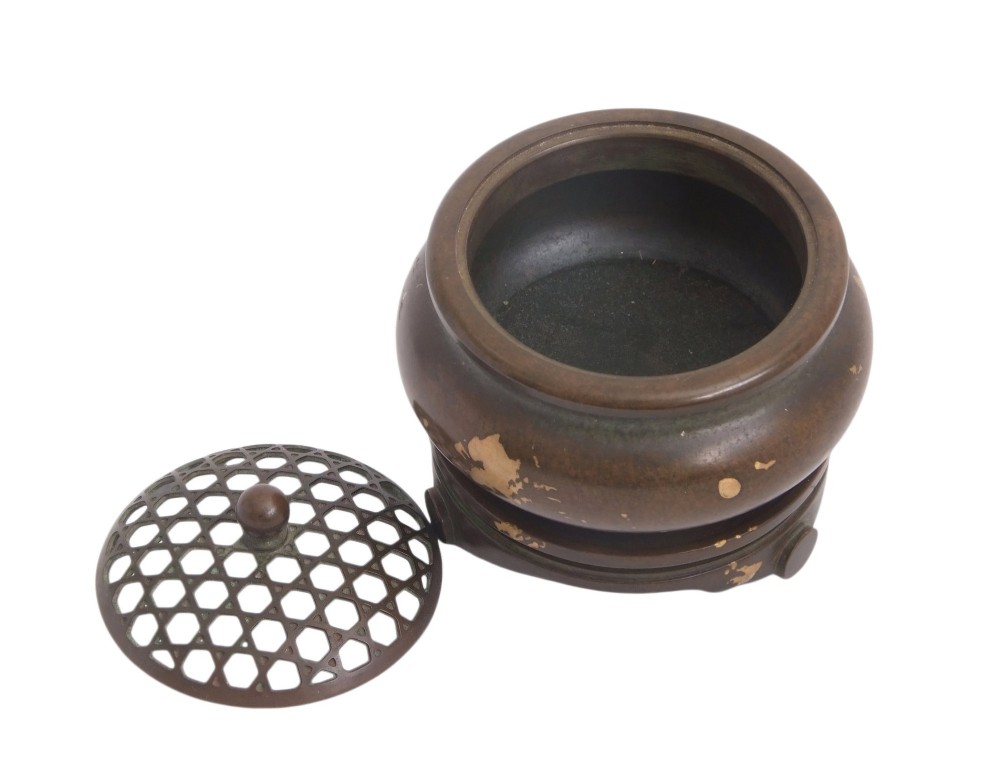 A dark brown bronze circular censer featuring gold splash decoration, a reticulated lattice cover with a spherical finial, and a matching footed bronze stand. View XII