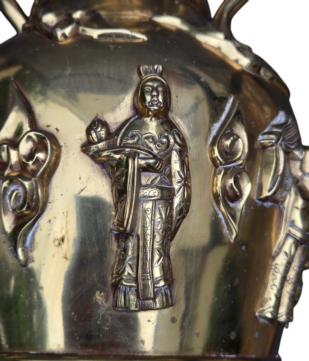 A late 19th-century Chinese brass baluster vase featuring raised high-relief carvings of Daoist figures, clouds, and floral handles. View VI