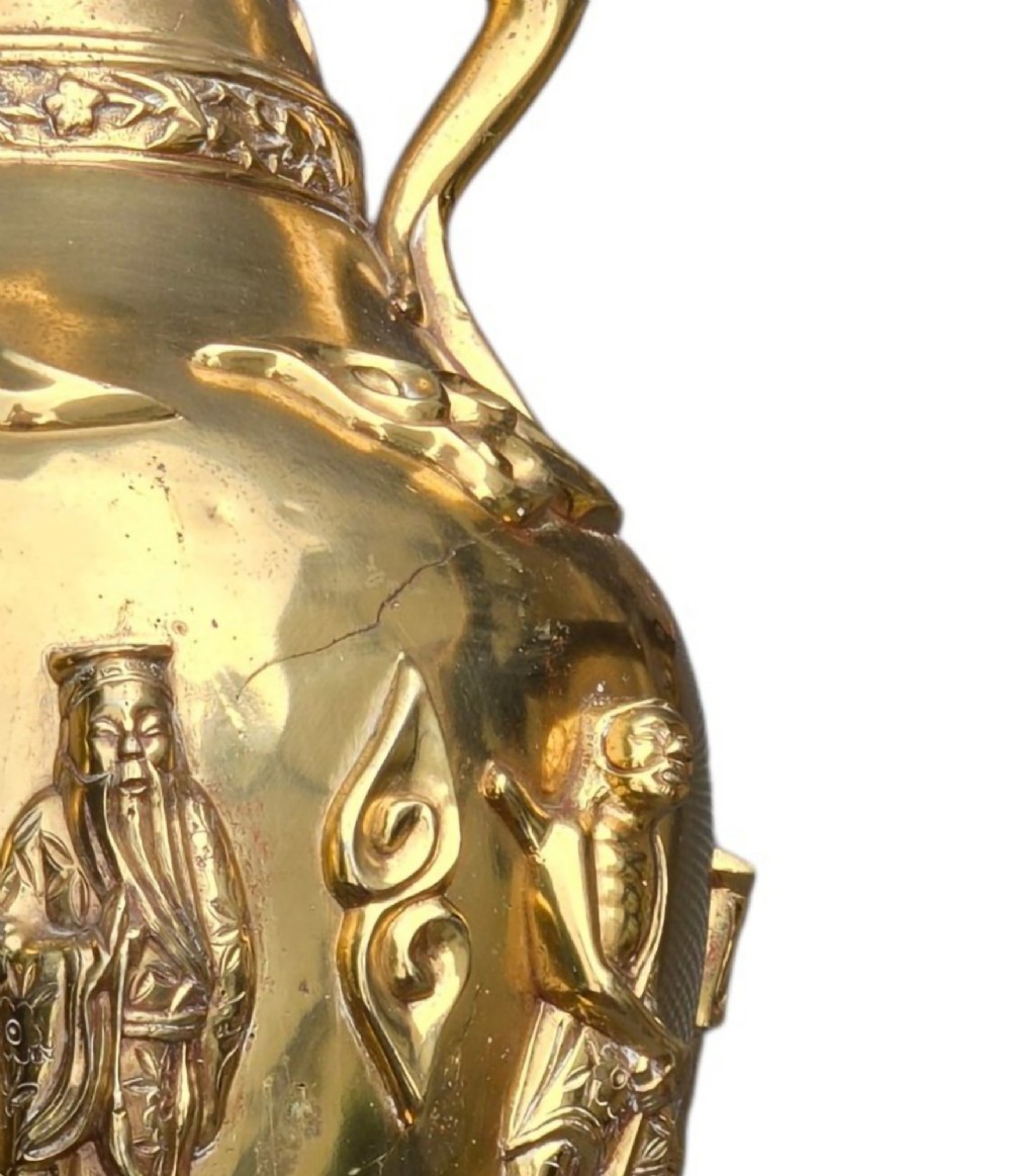 A late 19th-century Chinese brass baluster vase featuring raised high-relief carvings of Daoist figures, clouds, and floral handles. View XIII