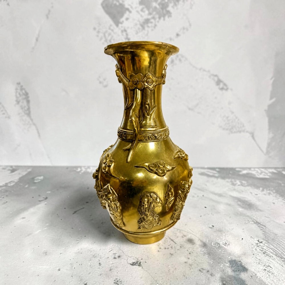 A late 19th-century Chinese brass baluster vase featuring raised high-relief carvings of Daoist figures, clouds, and floral handles. View XIV