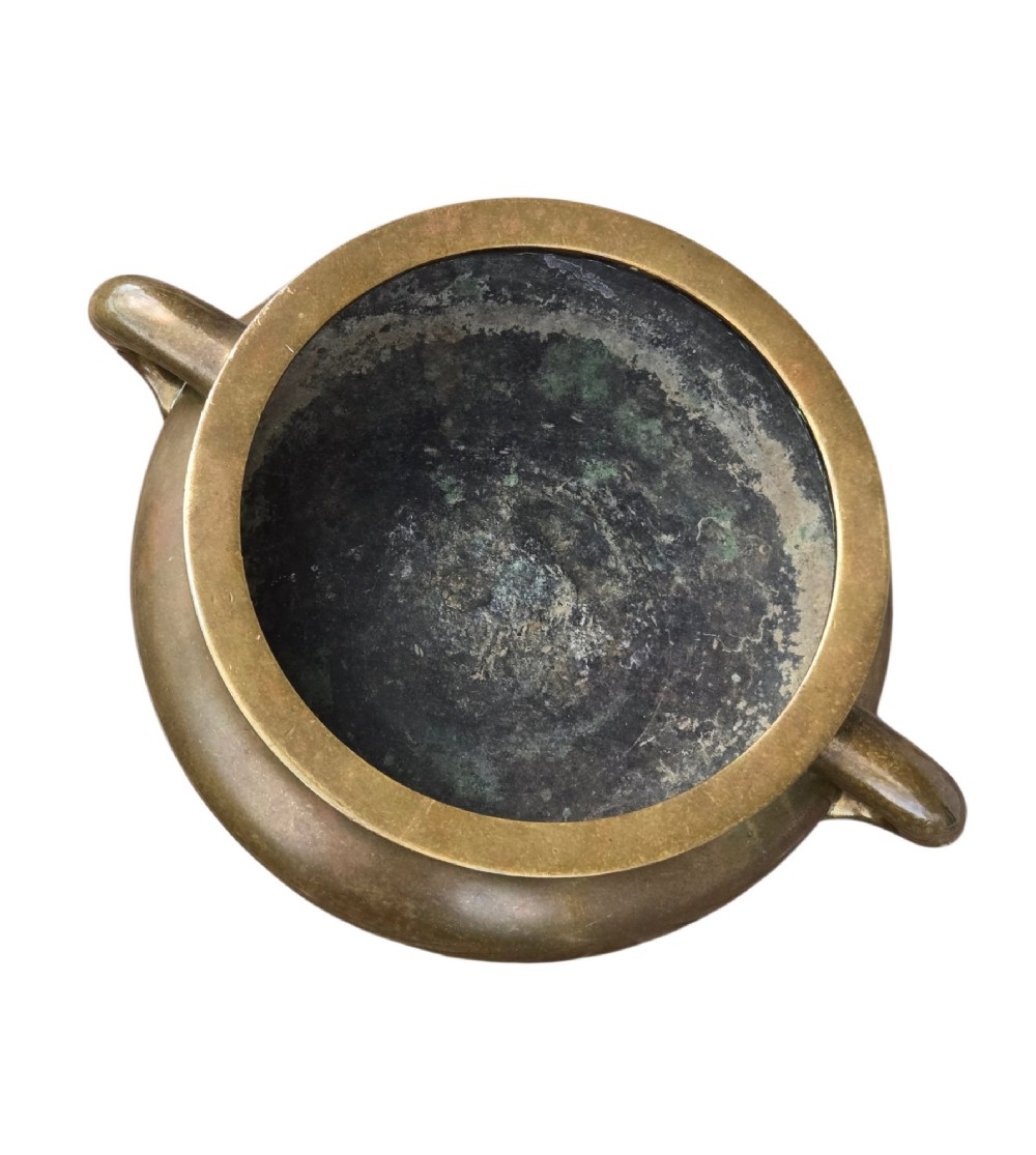 A heavy Chinese bronze ritual censer featuring twin loop handles and resting on a matching fitted base with shaped feet. View IX