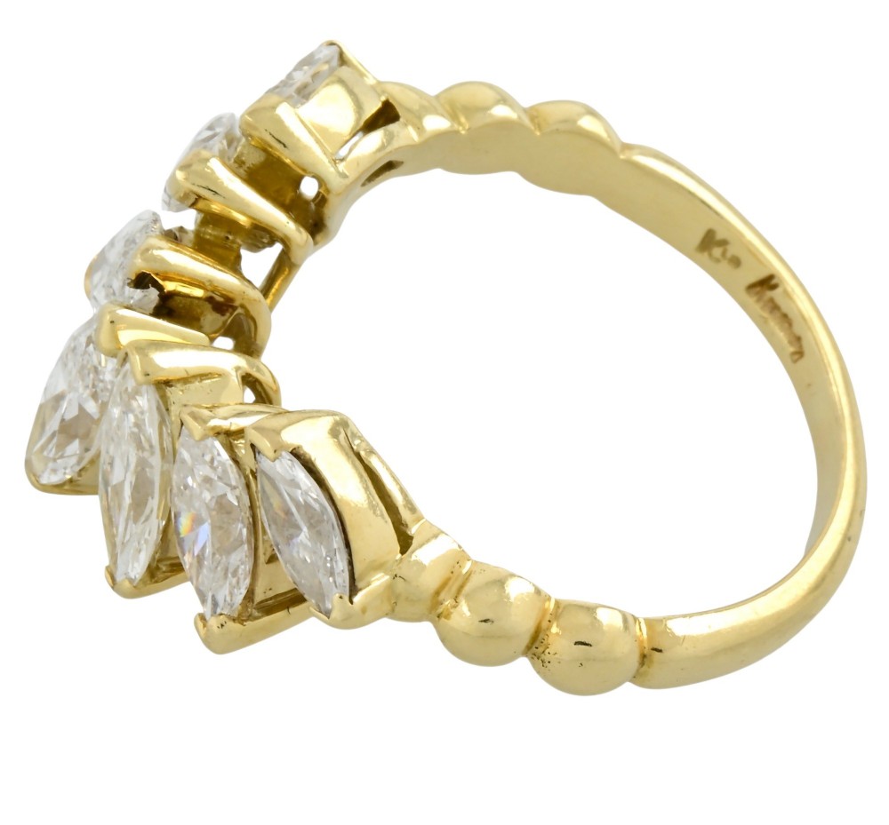 An 18ct yellow gold dress ring by Kutchinsky featuring a graduated row of marquise-cut diamonds mounted on a textured beaded shank. View V