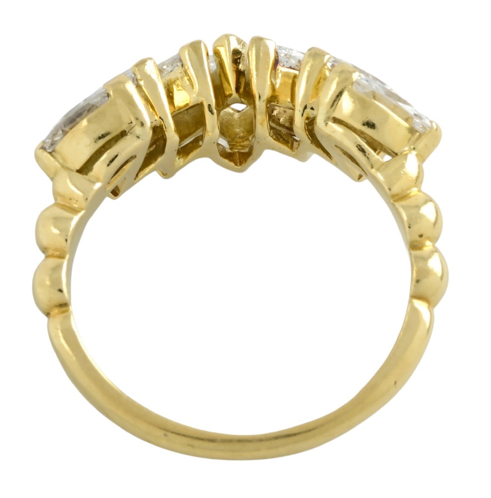 An 18ct yellow gold dress ring by Kutchinsky featuring a graduated row of marquise-cut diamonds mounted on a textured beaded shank. View VI