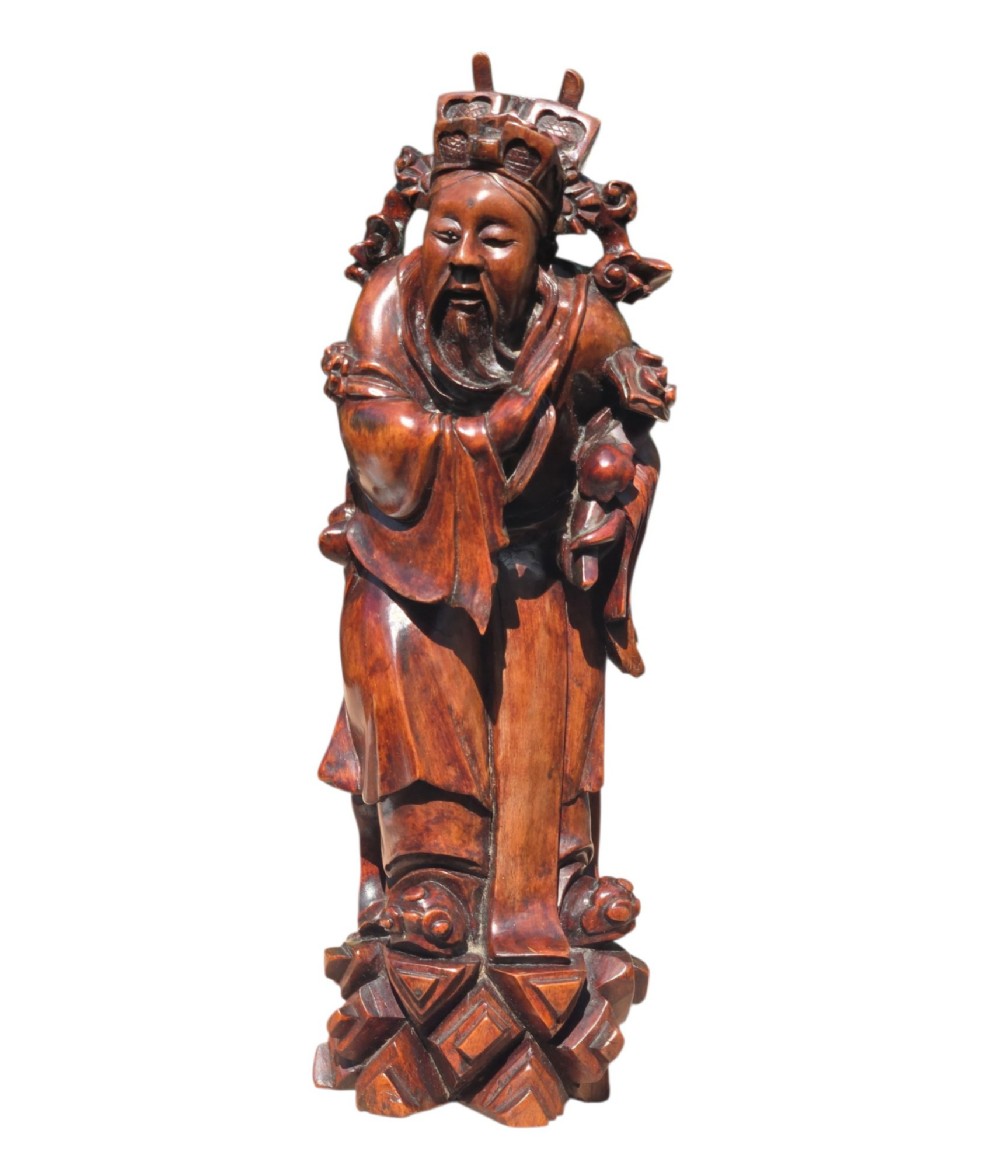 A pair of Chinese hardwood sculptures depicting Daoist immortals in flowing robes with carved geometric bases. View V
