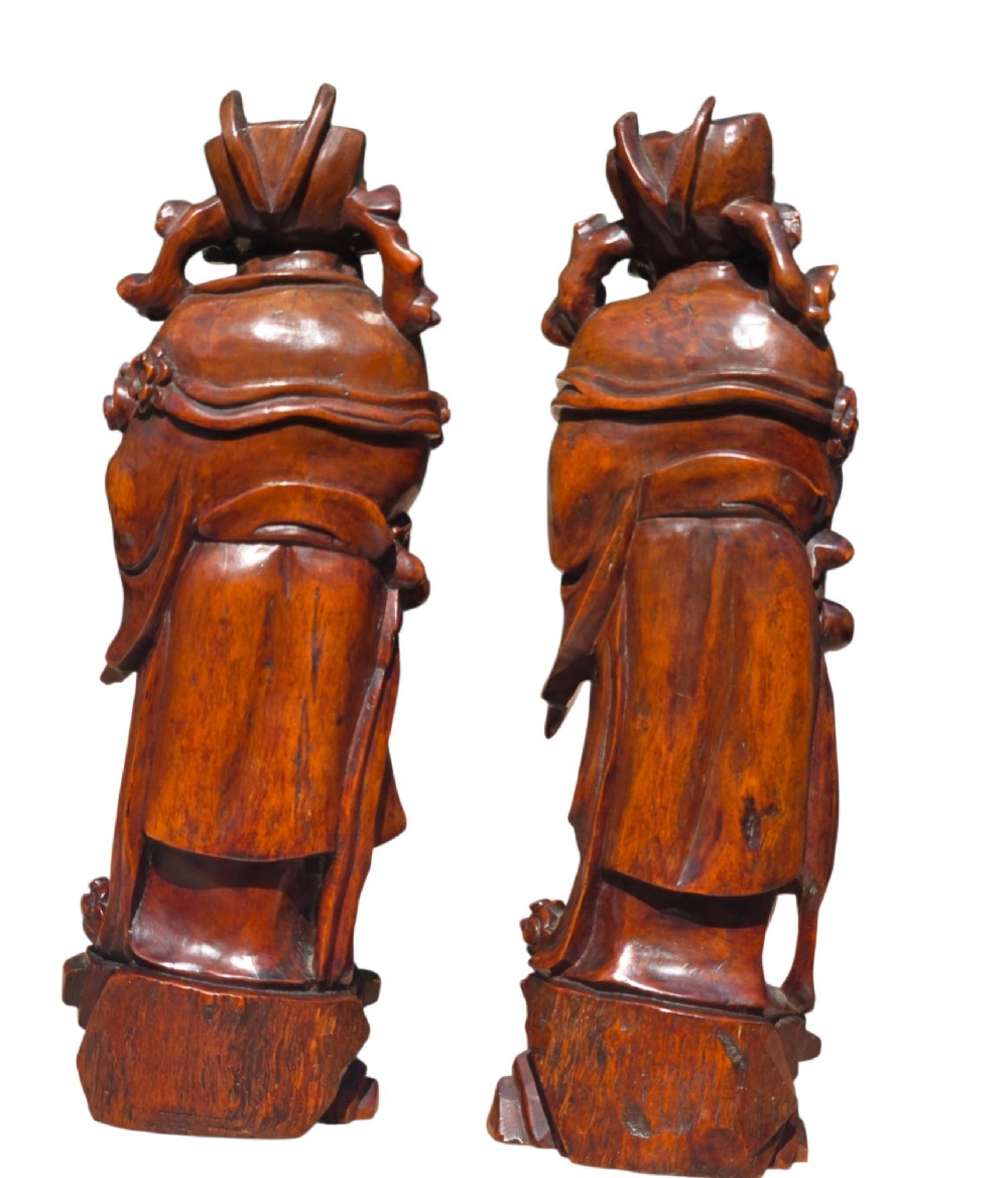 A pair of Chinese hardwood sculptures depicting Daoist immortals in flowing robes with carved geometric bases. View VII