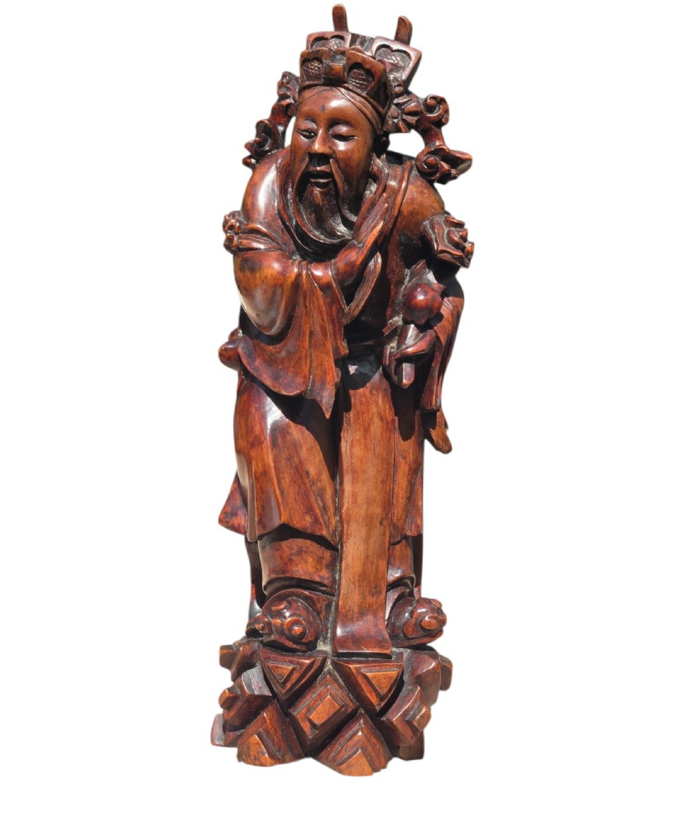 A pair of Chinese hardwood sculptures depicting Daoist immortals in flowing robes with carved geometric bases. View XIV