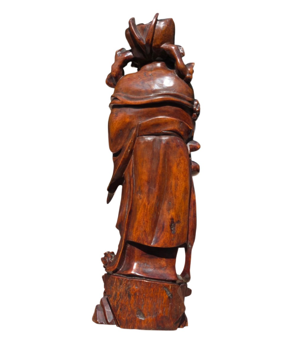 A pair of Chinese hardwood sculptures depicting Daoist immortals in flowing robes with carved geometric bases. View XV