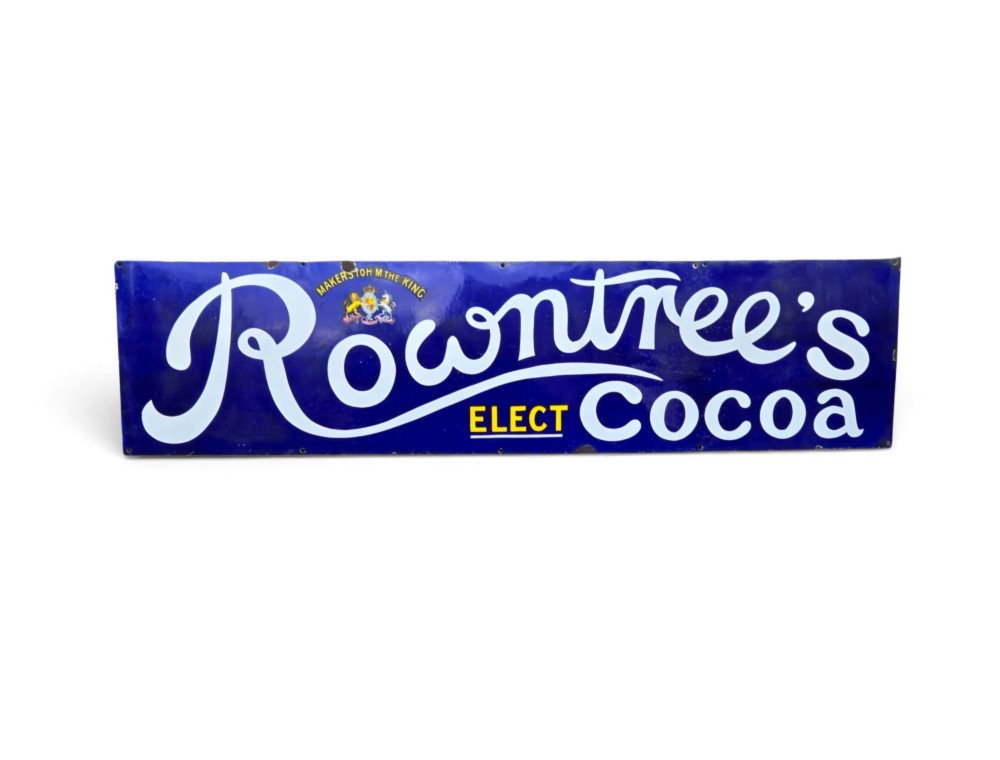 A rectangular cobalt blue vitreous enamel advertising sign featuring white script reading Rowntrees Cocoa and yellow lettering reading Elect Cocoa, topped with a royal warrant crest.