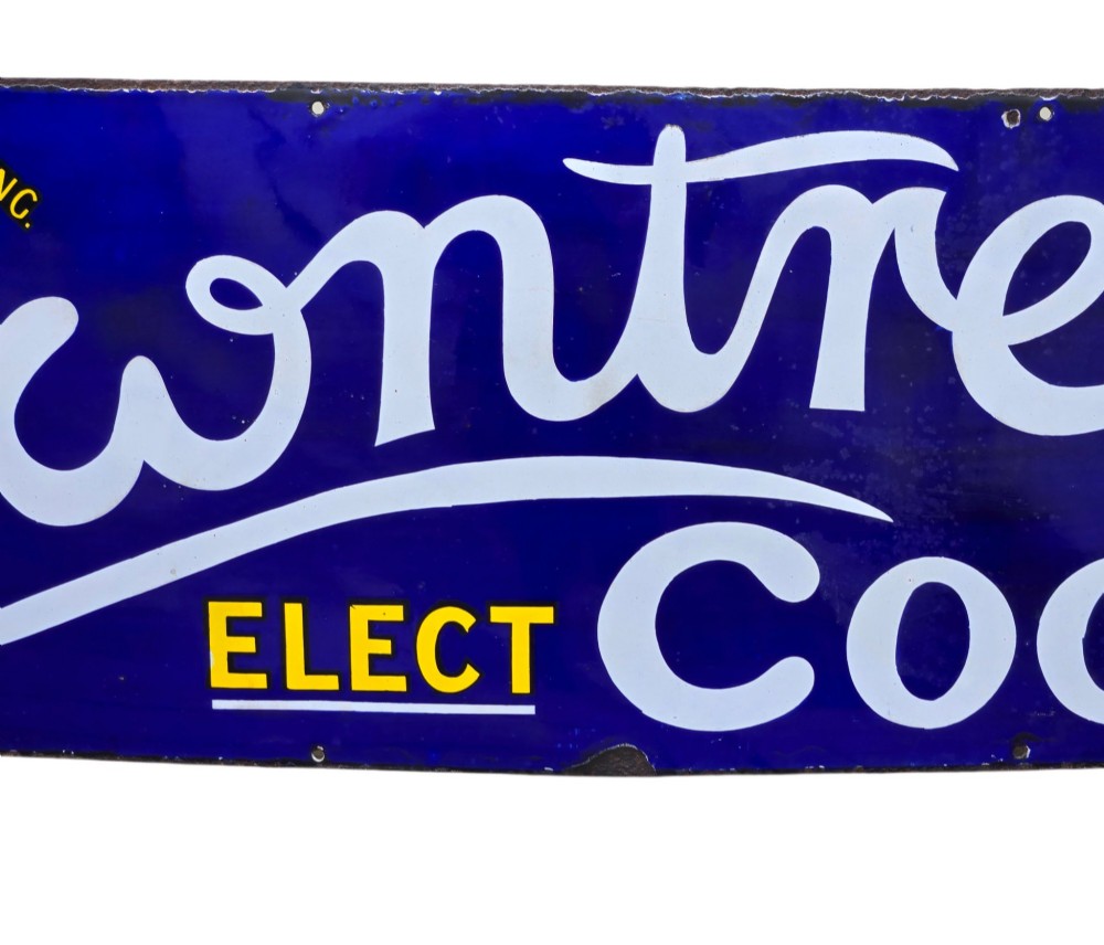 A rectangular cobalt blue vitreous enamel advertising sign featuring white script reading Rowntrees Cocoa and yellow lettering reading Elect Cocoa, topped with a royal warrant crest. View VIII