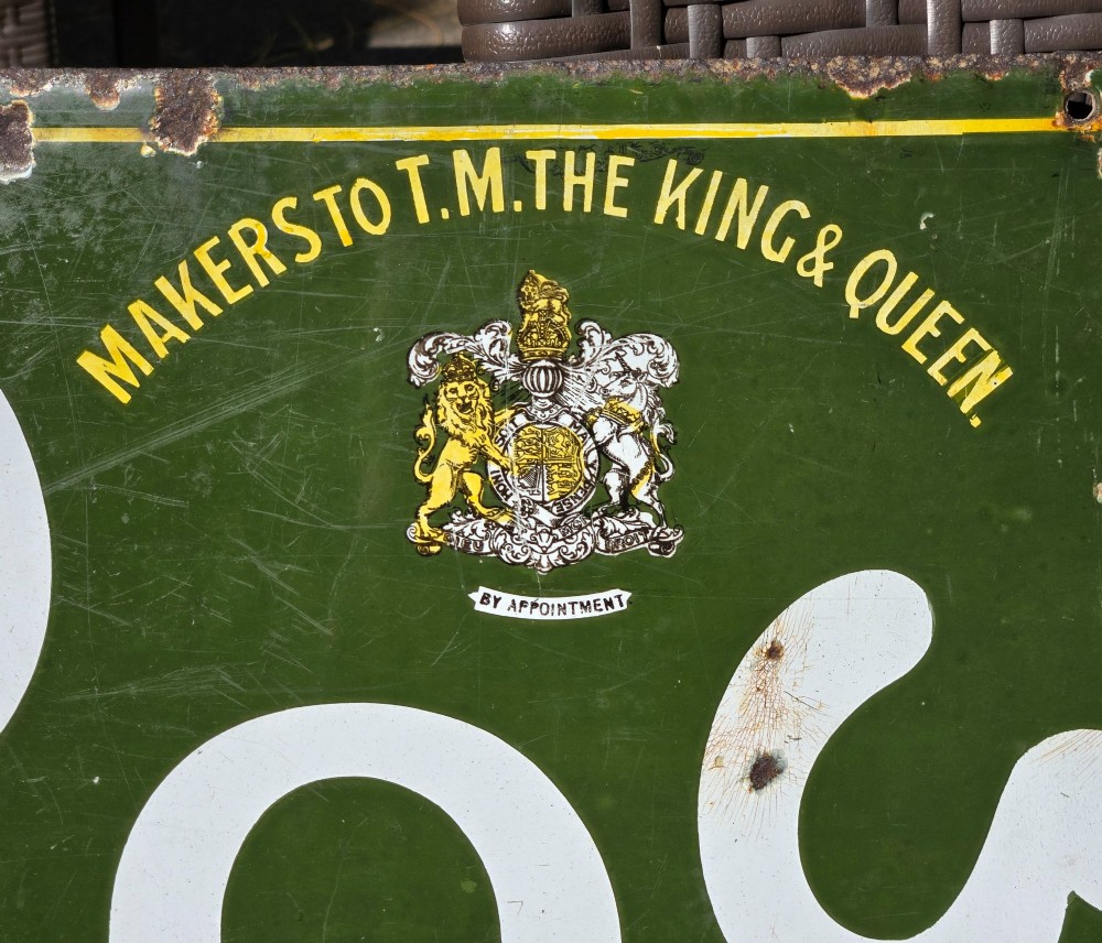 A large rectangular bottle green enamel sign featuring white and yellow typography for Rowntrees Elect Cocoa with a royal crest. View VIII