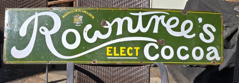 A large rectangular bottle green enamel sign featuring white and yellow typography for Rowntrees Elect Cocoa with a royal crest. View IX