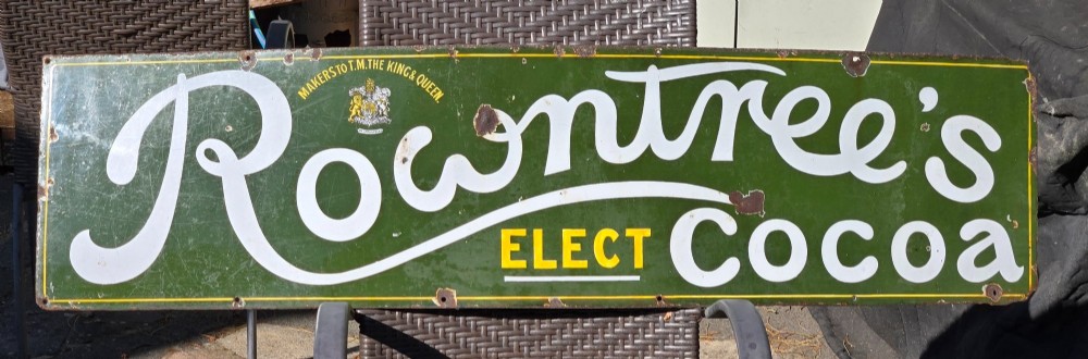 A large rectangular bottle green enamel sign featuring white and yellow typography for Rowntrees Elect Cocoa with a royal crest. View XII