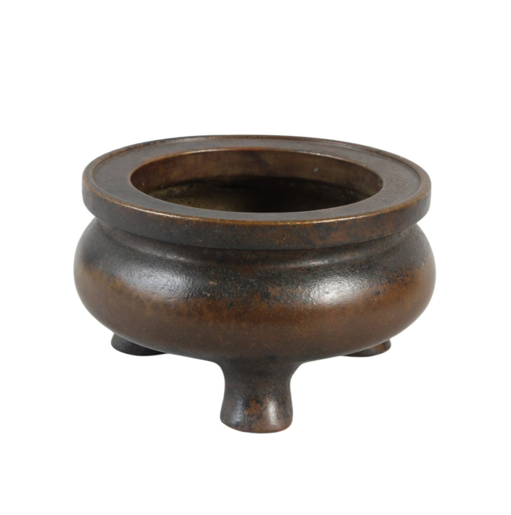 A heavy 17th-century Chinese archaistic bronze tripod censer featuring a compressed globular body, wide flat rim, dark brown patina, and three sturdy feet. View III