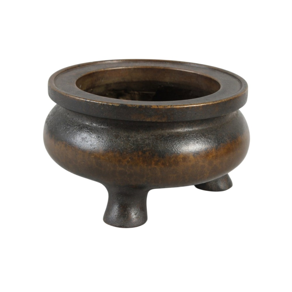 A heavy 17th-century Chinese archaistic bronze tripod censer featuring a compressed globular body, wide flat rim, dark brown patina, and three sturdy feet. View IV
