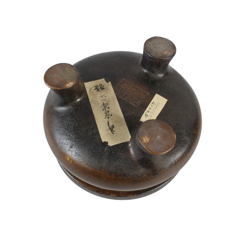 A heavy 17th-century Chinese archaistic bronze tripod censer featuring a compressed globular body, wide flat rim, dark brown patina, and three sturdy feet. View VII