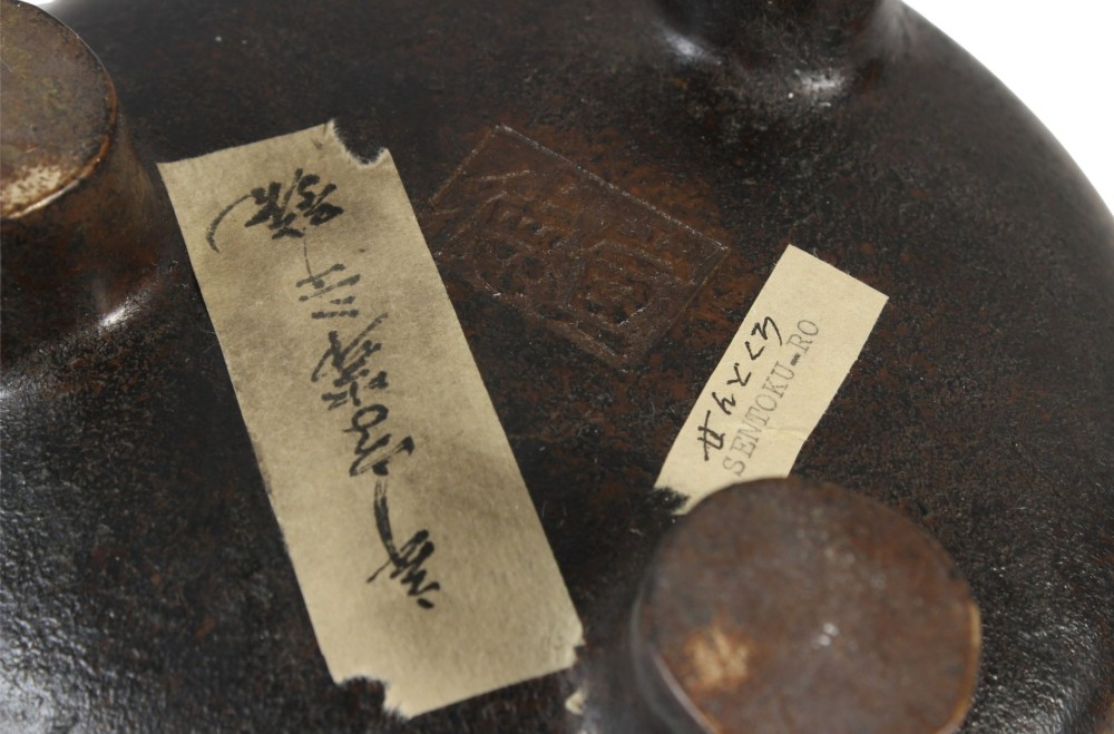 A heavy 17th-century Chinese archaistic bronze tripod censer featuring a compressed globular body, wide flat rim, dark brown patina, and three sturdy feet. View VIII