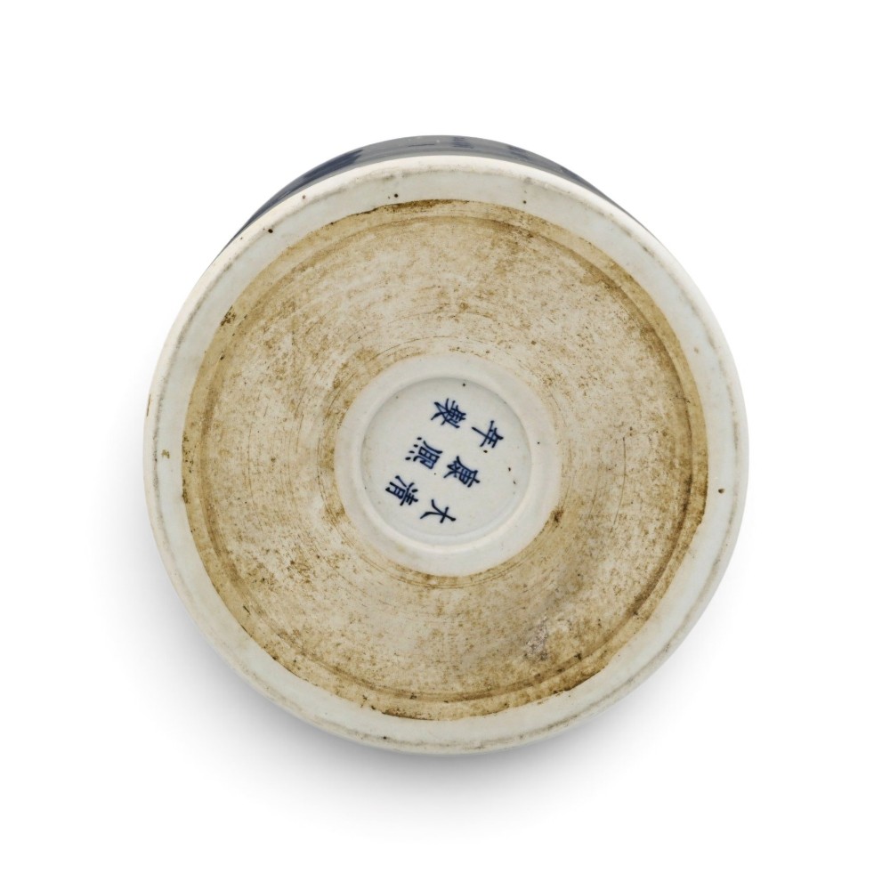 A cylindrical Chinese blue and white porcelain brush pot decorated with a painted mountain landscape and calligraphic text. View V