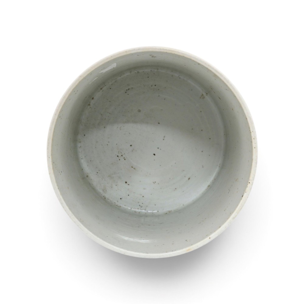 A cylindrical Chinese blue and white porcelain brush pot decorated with a painted mountain landscape and calligraphic text. View VI