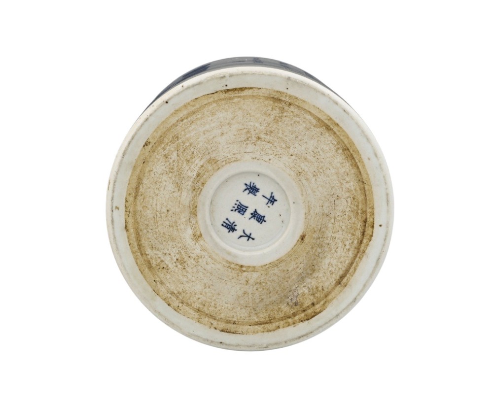 A cylindrical Chinese blue and white porcelain brush pot decorated with a painted mountain landscape and calligraphic text. View VII