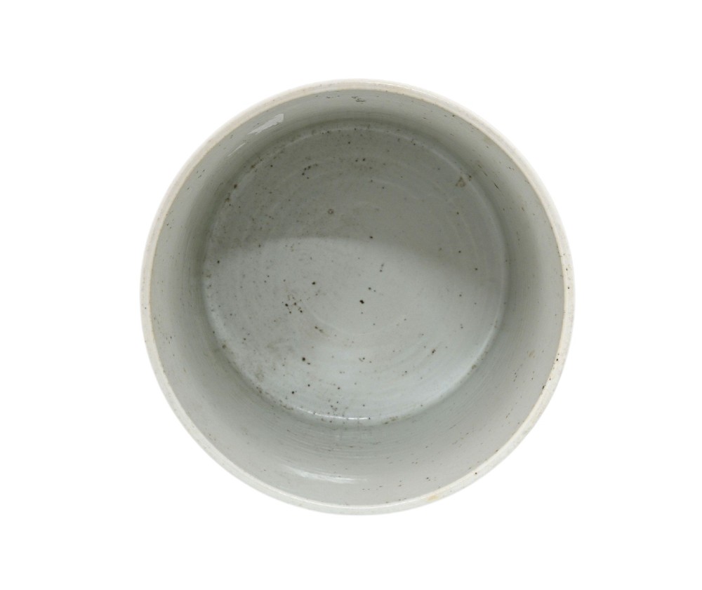 A cylindrical Chinese blue and white porcelain brush pot decorated with a painted mountain landscape and calligraphic text. View VIII