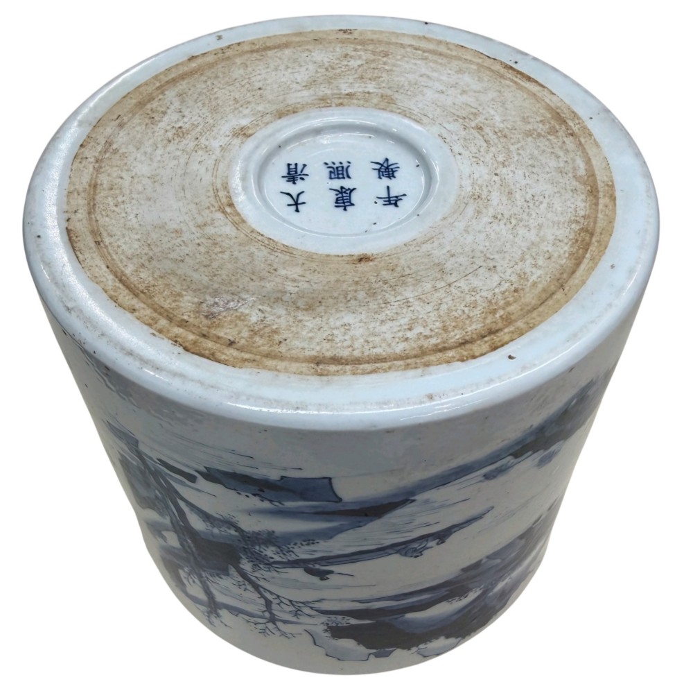 A cylindrical Chinese blue and white porcelain brush pot decorated with a painted mountain landscape and calligraphic text. View XII