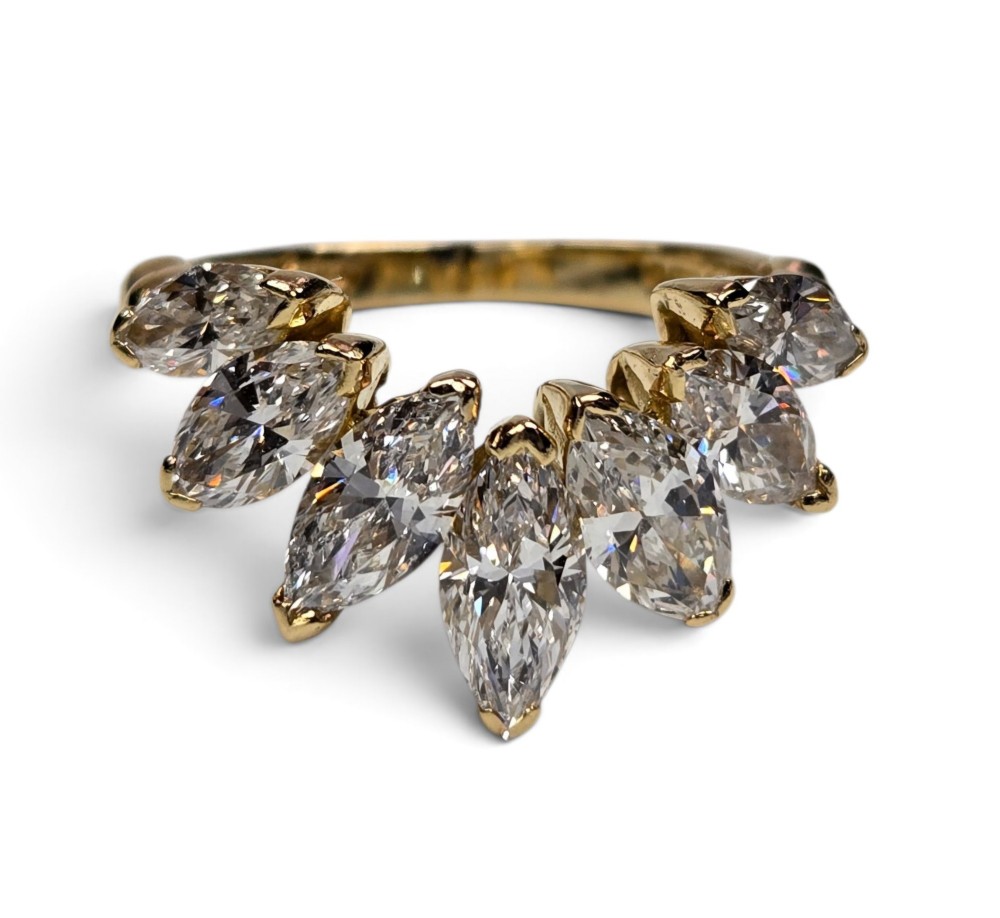 An 18ct yellow gold dress ring by Kutchinsky featuring a graduated row of marquise-cut diamonds mounted on a textured beaded shank. View III