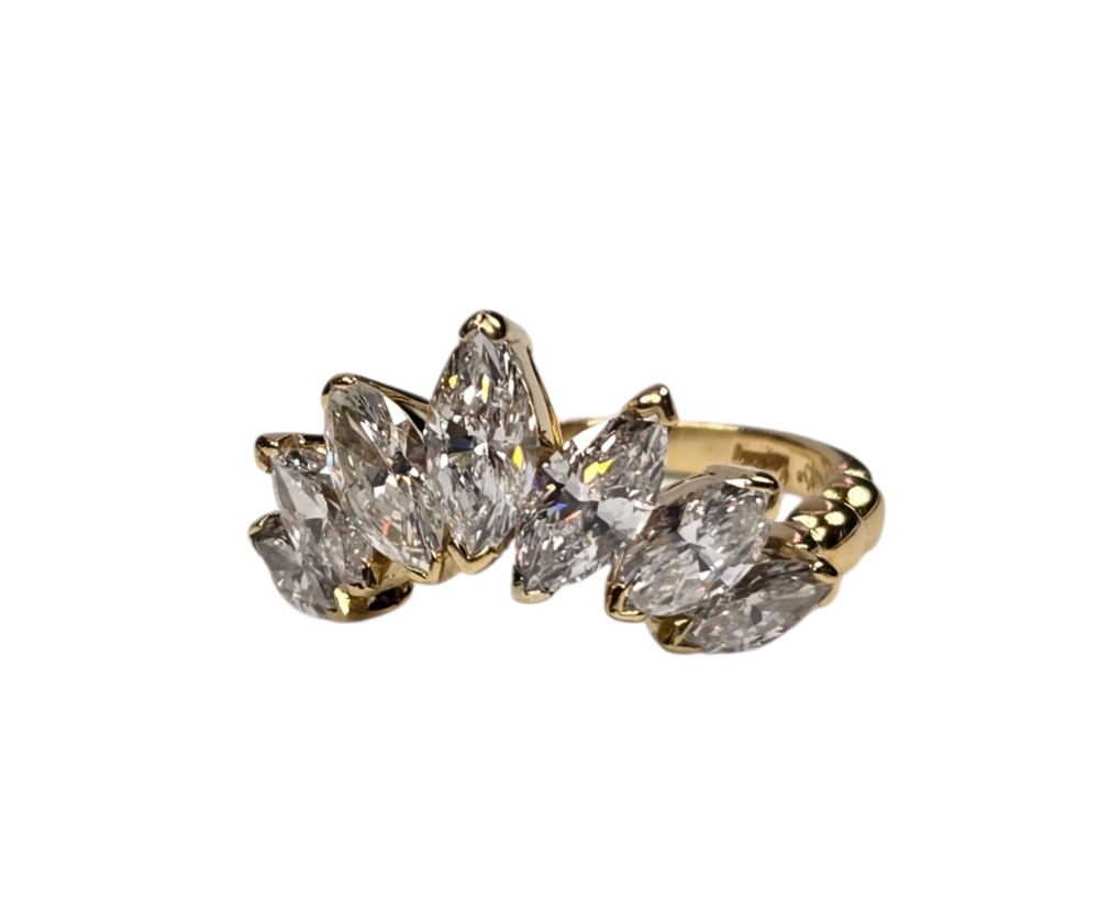 An 18ct yellow gold dress ring by Kutchinsky featuring a graduated row of marquise-cut diamonds mounted on a textured beaded shank. View X