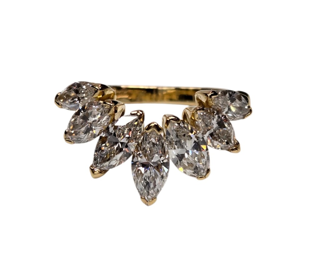 An 18ct yellow gold dress ring by Kutchinsky featuring a graduated row of marquise-cut diamonds mounted on a textured beaded shank. View XI