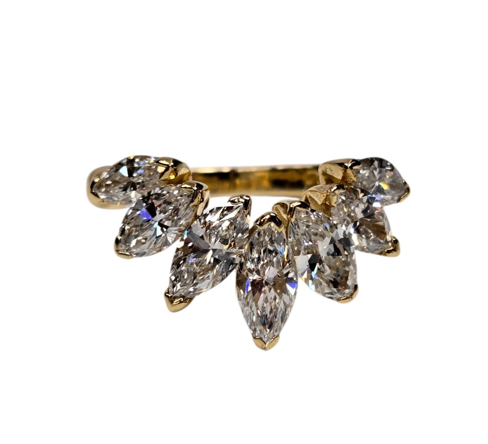 An 18ct yellow gold dress ring by Kutchinsky featuring a graduated row of marquise-cut diamonds mounted on a textured beaded shank. View XIV