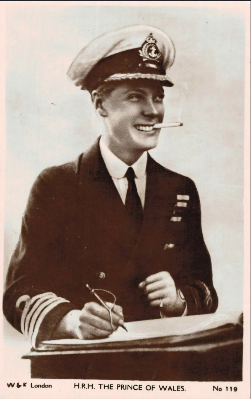 A framed 1931 pastel portrait drawing depicting a smiling man in a naval uniform smoking a cigarette against a dark background within a double mount and dark wood frame. View XI