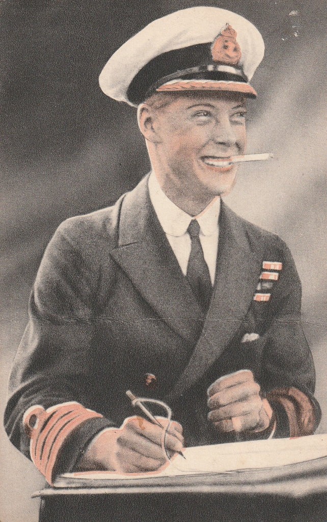 A framed 1931 pastel portrait drawing depicting a smiling man in a naval uniform smoking a cigarette against a dark background within a double mount and dark wood frame. View XII