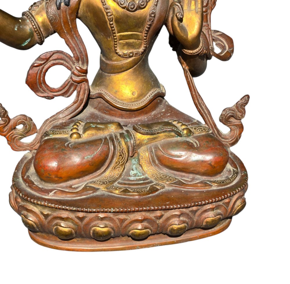 An antique Sino-Tibetan gilt-bronze figure of Bodhisattva Manjushri seated cross-legged on a double-lotus base, brandishing a flaming sword in his right hand. View X