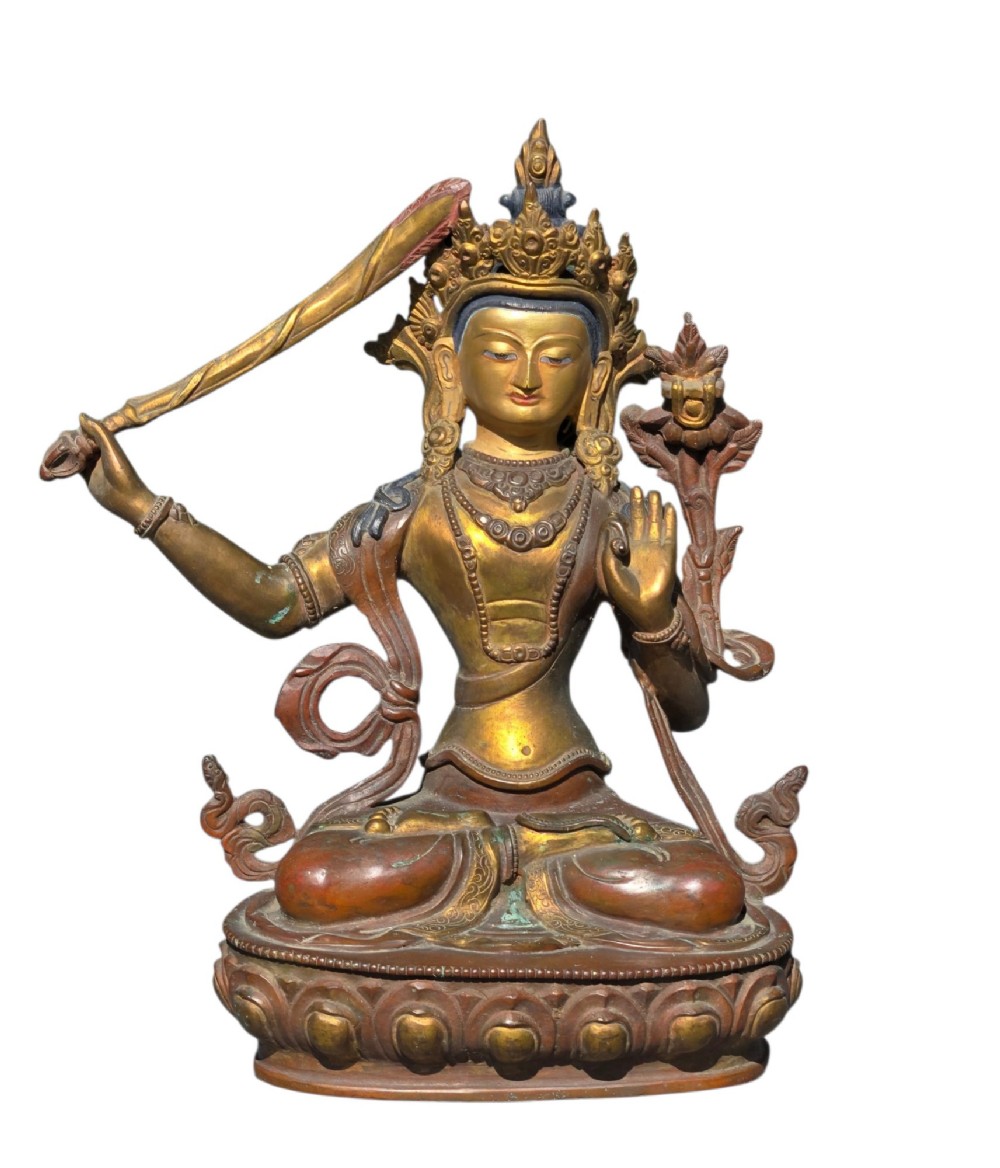 An antique Sino-Tibetan gilt-bronze figure of Bodhisattva Manjushri seated cross-legged on a double-lotus base, brandishing a flaming sword in his right hand. View XIII
