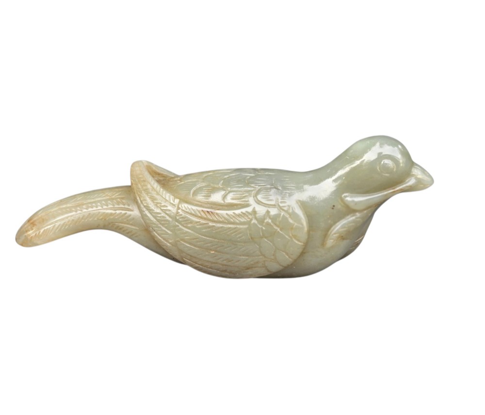 A carved celadon jade figure depicting a resting water bird holding a leafy stem in its beak. View X