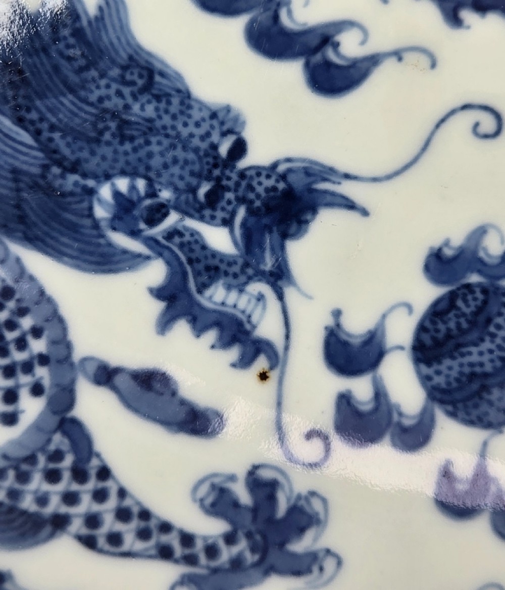 A circular Chinese blue and white porcelain charger featuring five-clawed dragons depicted among stylized clouds and flaming pearls. View VIII