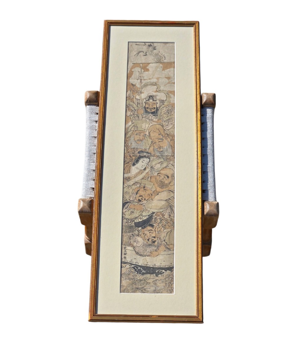 A tall framed Japanese ukiyo-e woodblock print depicting seven figures aboard a vessel beneath a flying crane, presented in a gold frame with a wide cream mount. View XIII