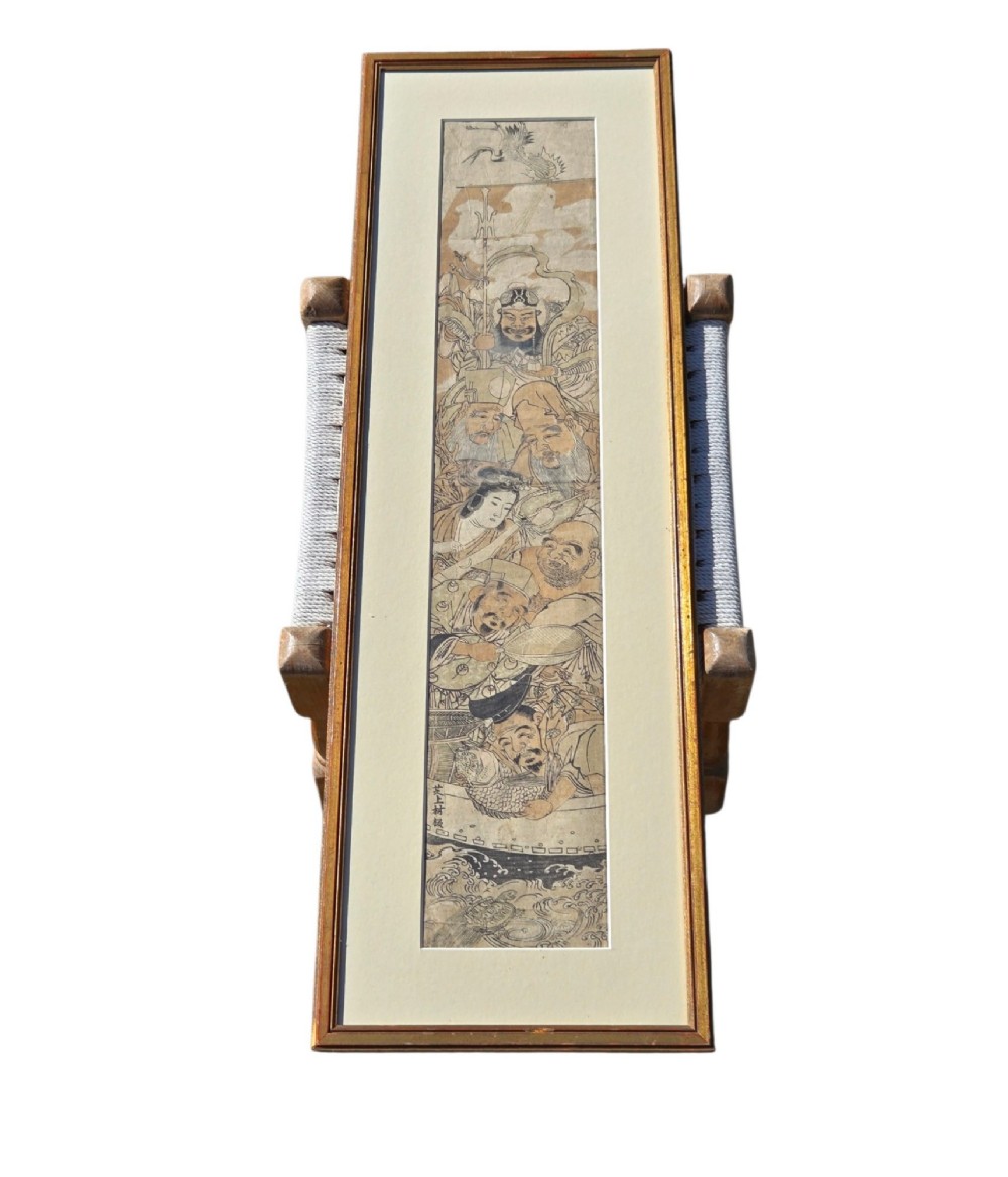 A tall framed Japanese ukiyo-e woodblock print depicting seven figures aboard a vessel beneath a flying crane, presented in a gold frame with a wide cream mount. View XIV