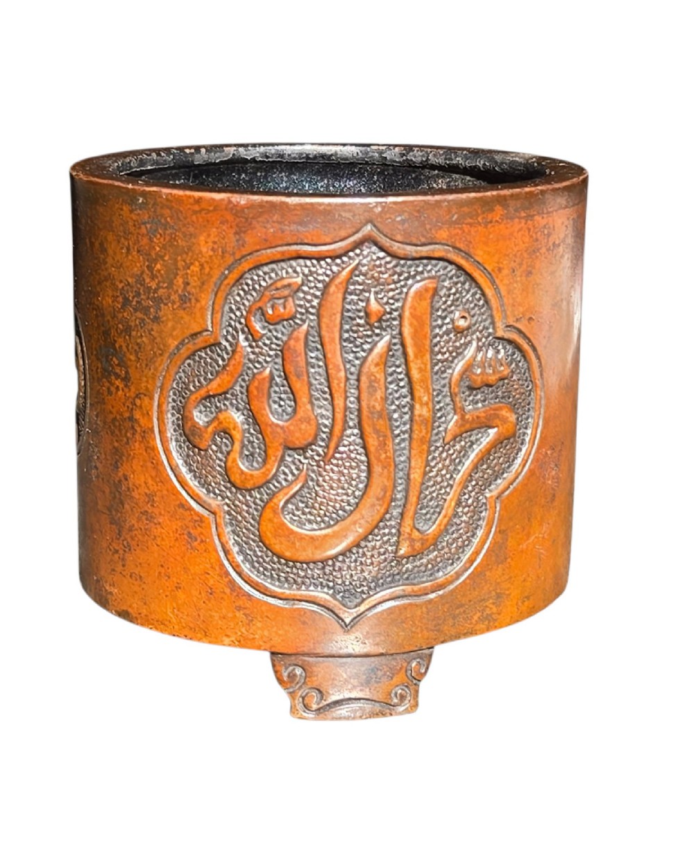 A cylindrical warm brown bronze tripod censer featuring a raised lobed cartouche with Arabic calligraphy set against a textured ground. View VI