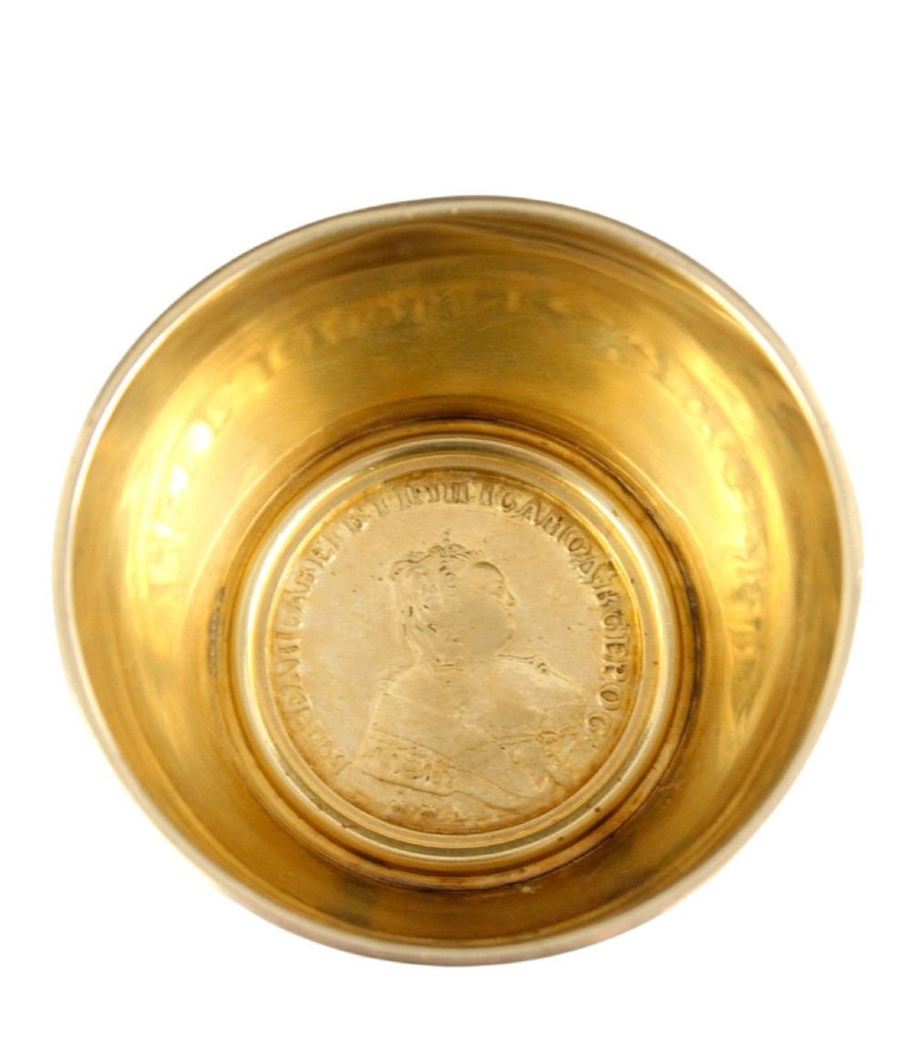 A circular gold silver-gilt presentation bowl featuring an engraved monogram and a carved leaf border near the upper rim. View VI