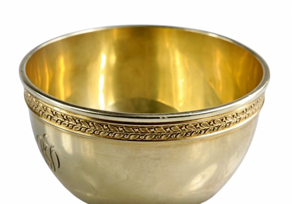 A circular gold silver-gilt presentation bowl featuring an engraved monogram and a carved leaf border near the upper rim. View VIII