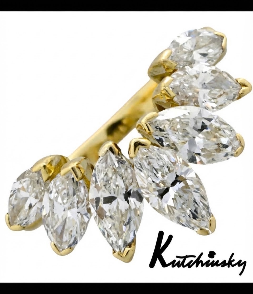 An 18ct yellow gold dress ring by Kutchinsky featuring a graduated row of marquise-cut diamonds mounted on a textured beaded shank.