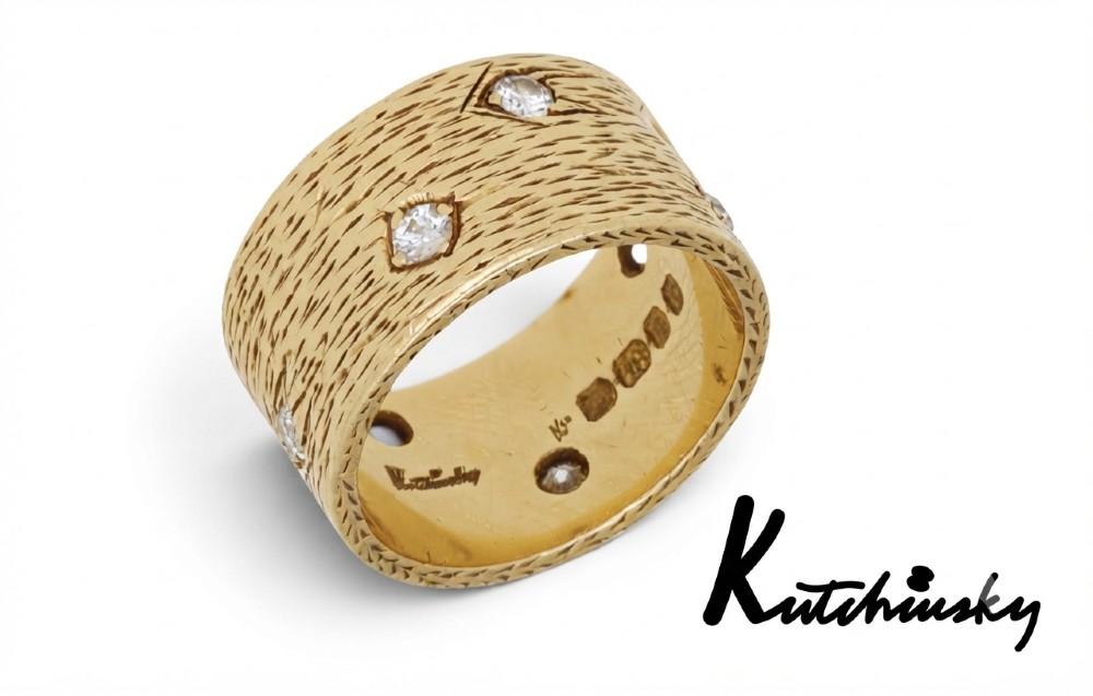 A wide 18ct yellow gold band ring featuring a textured bark-like surface set with brilliant-cut diamonds and stamped with London hallmarks inside. View II