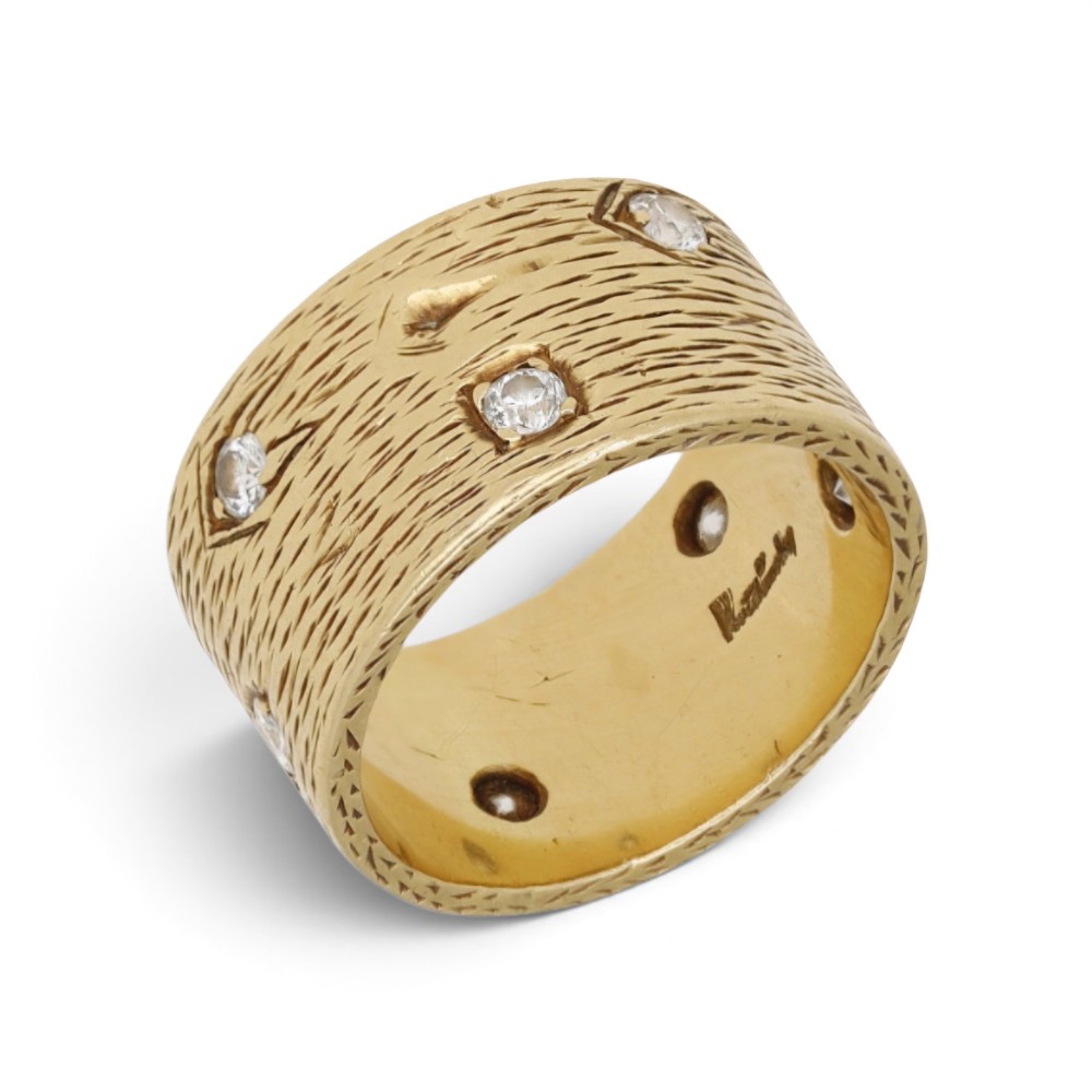A wide 18ct yellow gold band ring featuring a textured bark-like surface set with brilliant-cut diamonds and stamped with London hallmarks inside. View III