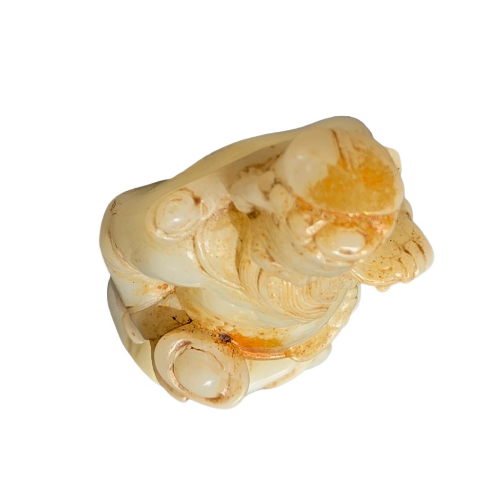 A carved pale celadon and russet nephrite jade standing figure of an immortal holding a vessel on a carved rockwork base. View XIII