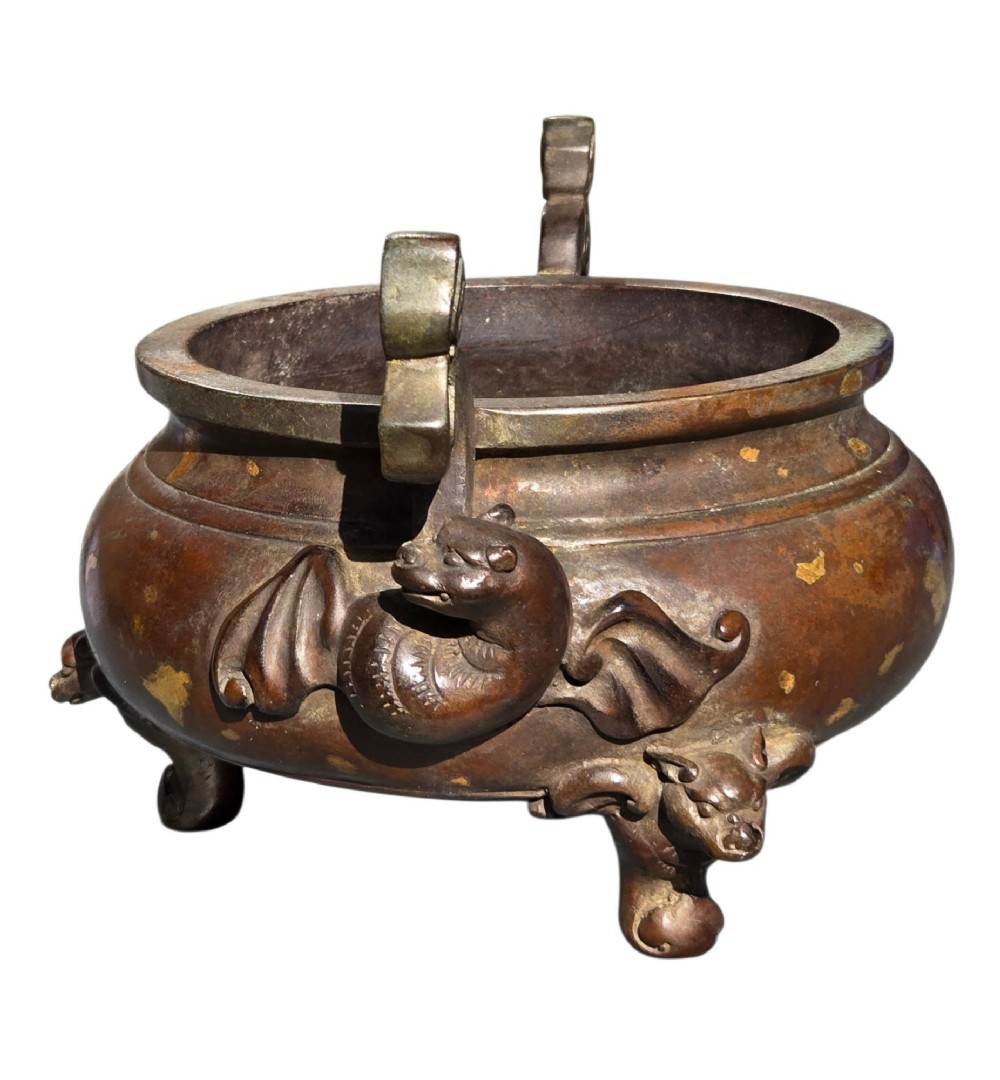 An 18th-century Chinese gilt-splashed bronze tripod censer featuring scroll handles, animal-mask legs, a dark hardwood cover topped with a carved jade finial, and a fitted bronze stand. View IV
